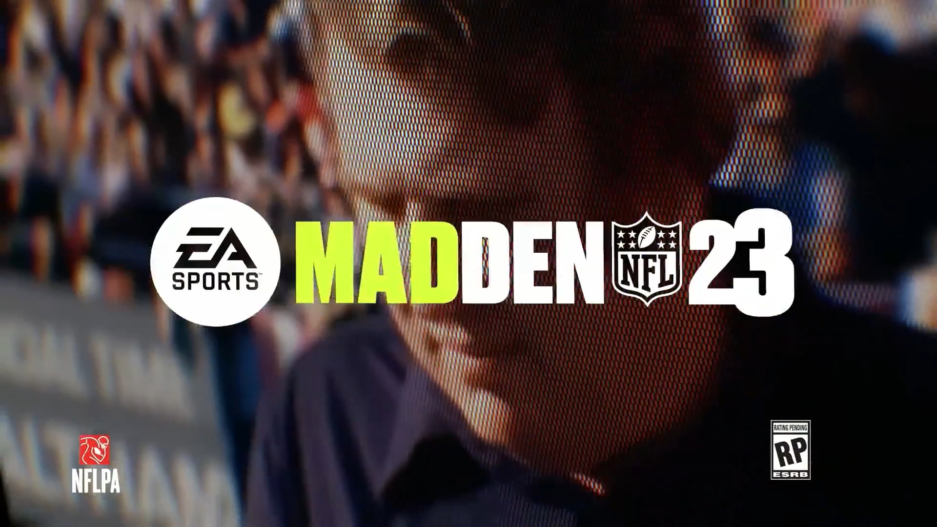 Cover art for the video game Madden NFL 23, featuring text that reads "EA Sports Madden NFL 23" with logos for EA Sports and the NFL. In the background is a close-up image of a person with blurred stadium crowd in the background. The game is rated "RP" for Rating Pending.