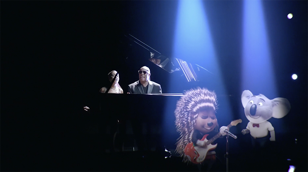A spotlight illuminates a pianist seated at a grand piano, while animated characters, including a porcupine playing an electric guitar and a koala in a suit with a red bow tie, perform against the dark, stage-like background.