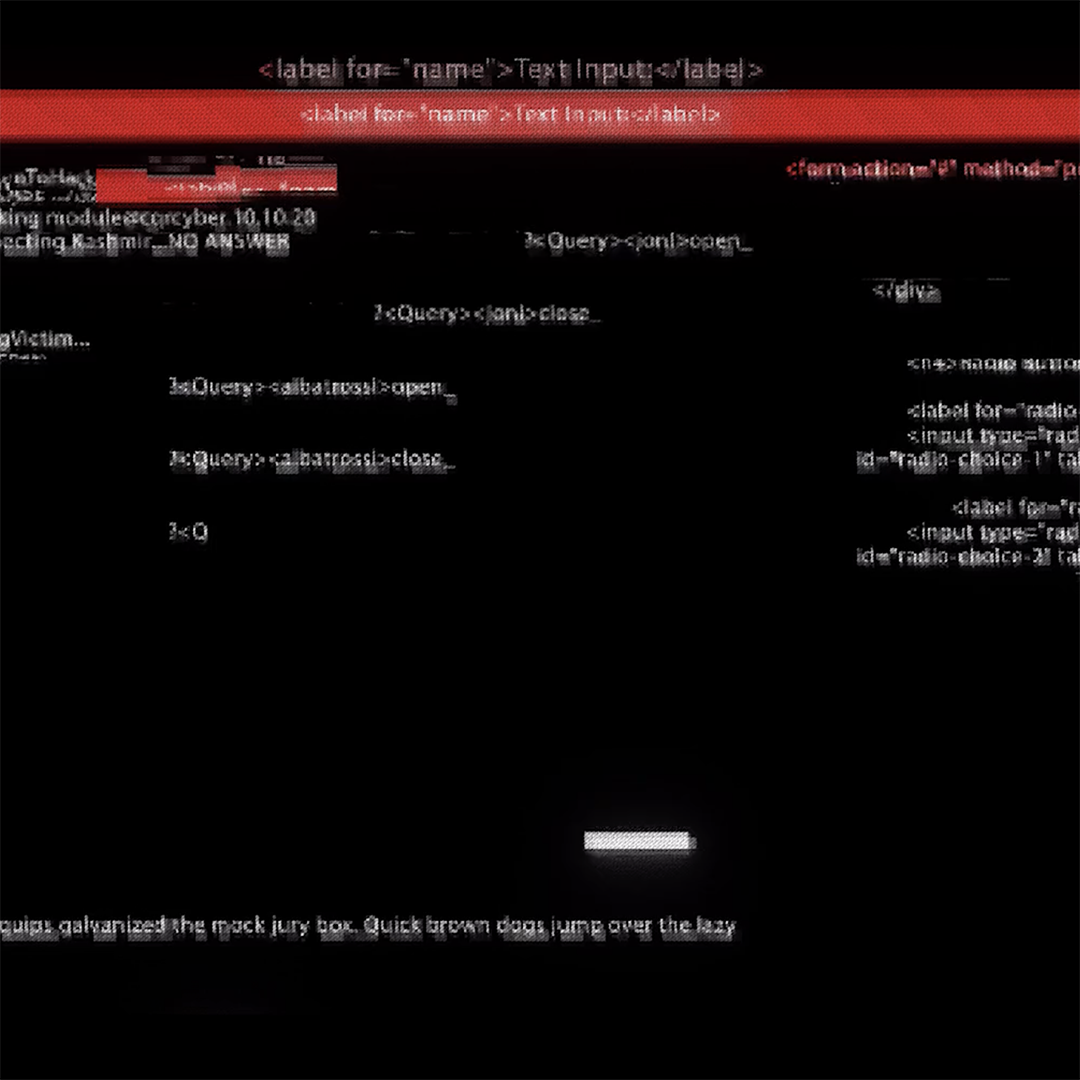 A computer screen displays a coding environment with lines of HTML and JavaScript code. Some lines are highlighted, and there are text input elements on the page. The screen has a dark theme with white and red text.
